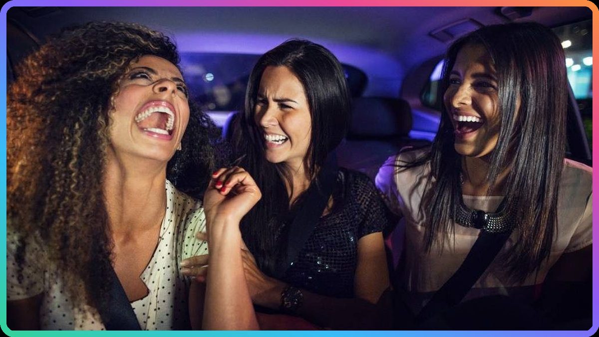 Riders laughing in the backseat, adding songs to the ride's queue